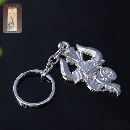Silver metal Trishul Damru keychain shown on a white background