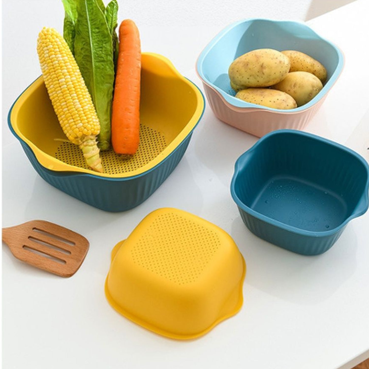 Plastic washing bowl and strainer basket displayed on a kitchen counter.