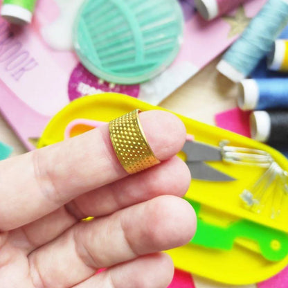 Complete tailoring sewing kit set including bobbins, threads, and safety pins for repairs