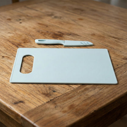 Ergonomic chopping board shown with matching kitchen knife for home cooking