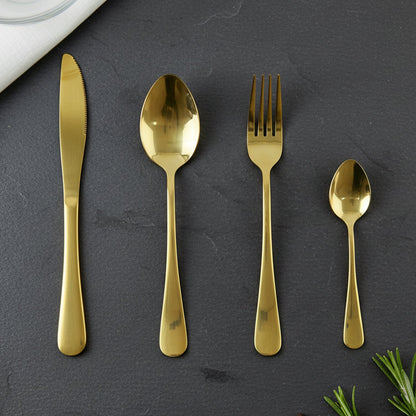 Gold spoons, forks, and knives laid out showcasing the set's completeness