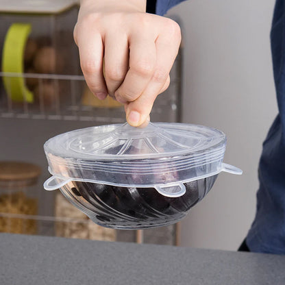 The reusable silicone food covers shown stretching to fit diverse container shapes and sizes.