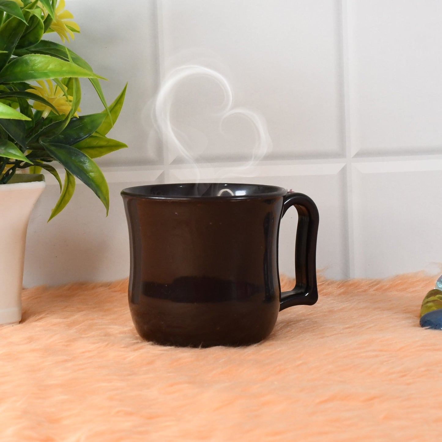 Stack of three black plastic coffee mugs, emphasizing their compact storage.