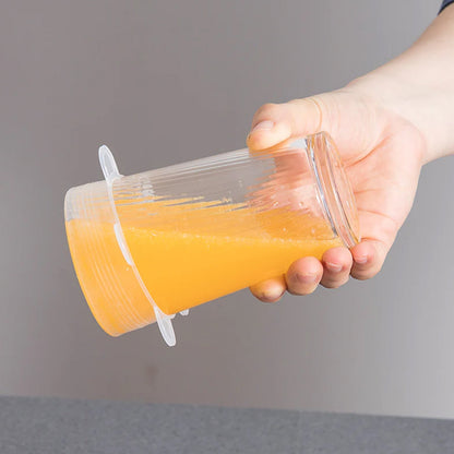 A silicone food cover sealing a small glass jar, preventing spills and maintaining freshness.