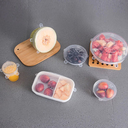 Clear silicone stretch lids covering plates with leftovers.