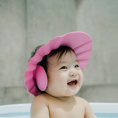 Water cascading over the adjustable baby shower cap, demonstrating effective eye protection