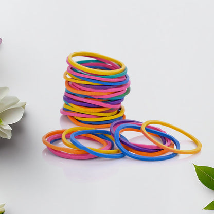 Multicolor rubber bands neatly arranged in a stack on a white surface.