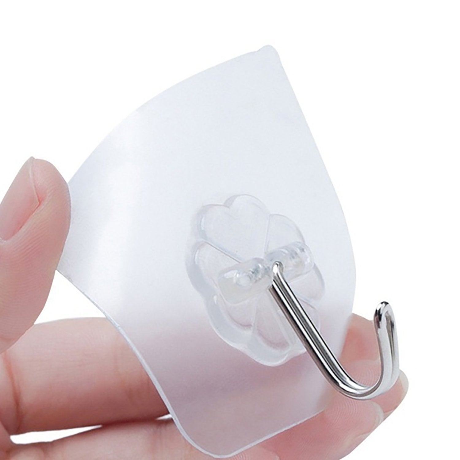 Two stainless steel adhesive hooks neatly organized on a kitchen wall.