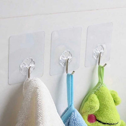 A single strong stainless steel adhesive hook holding a kitchen utensil on a tiled wall.