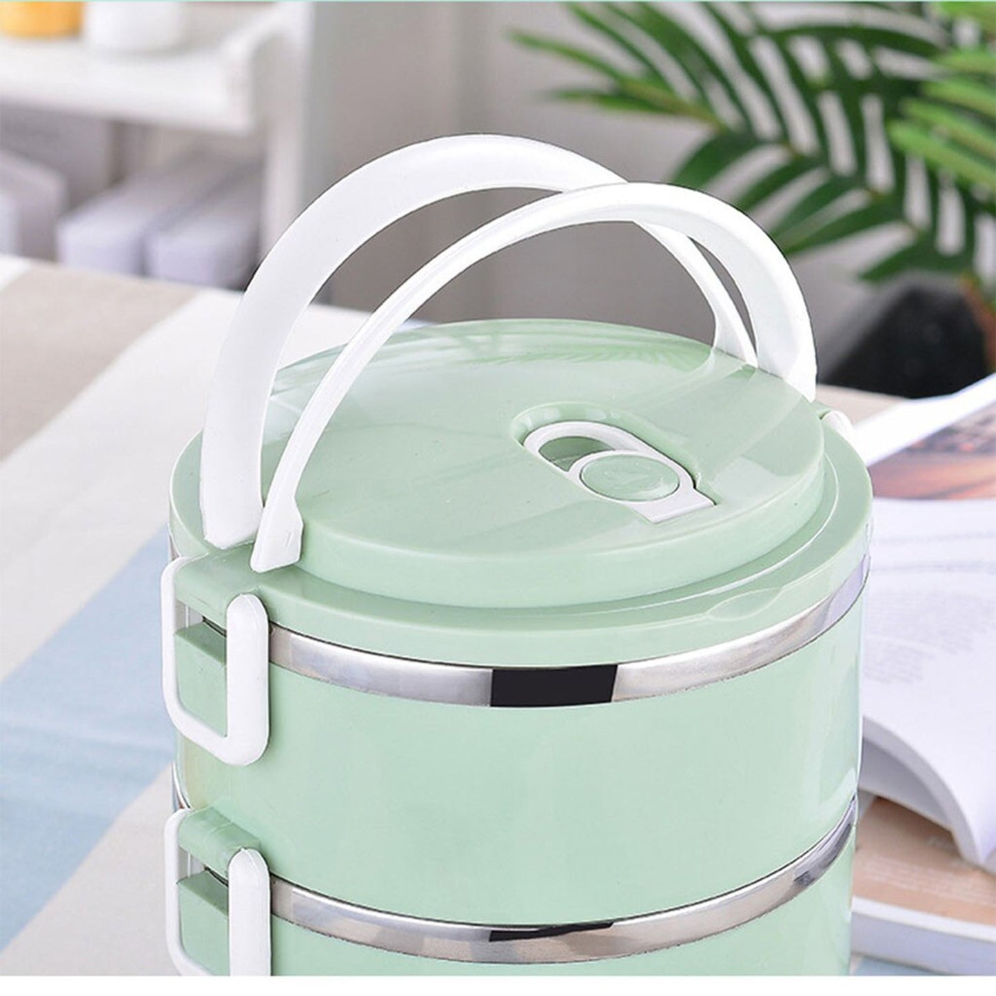 Ergonomic arched handle on the two-layer insulated lunch box for easy carrying.