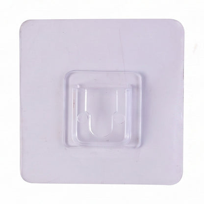 Transparent wall hook attached to a smooth surface for organization.