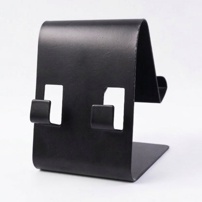 Black metal phone stand holding tablet at side view