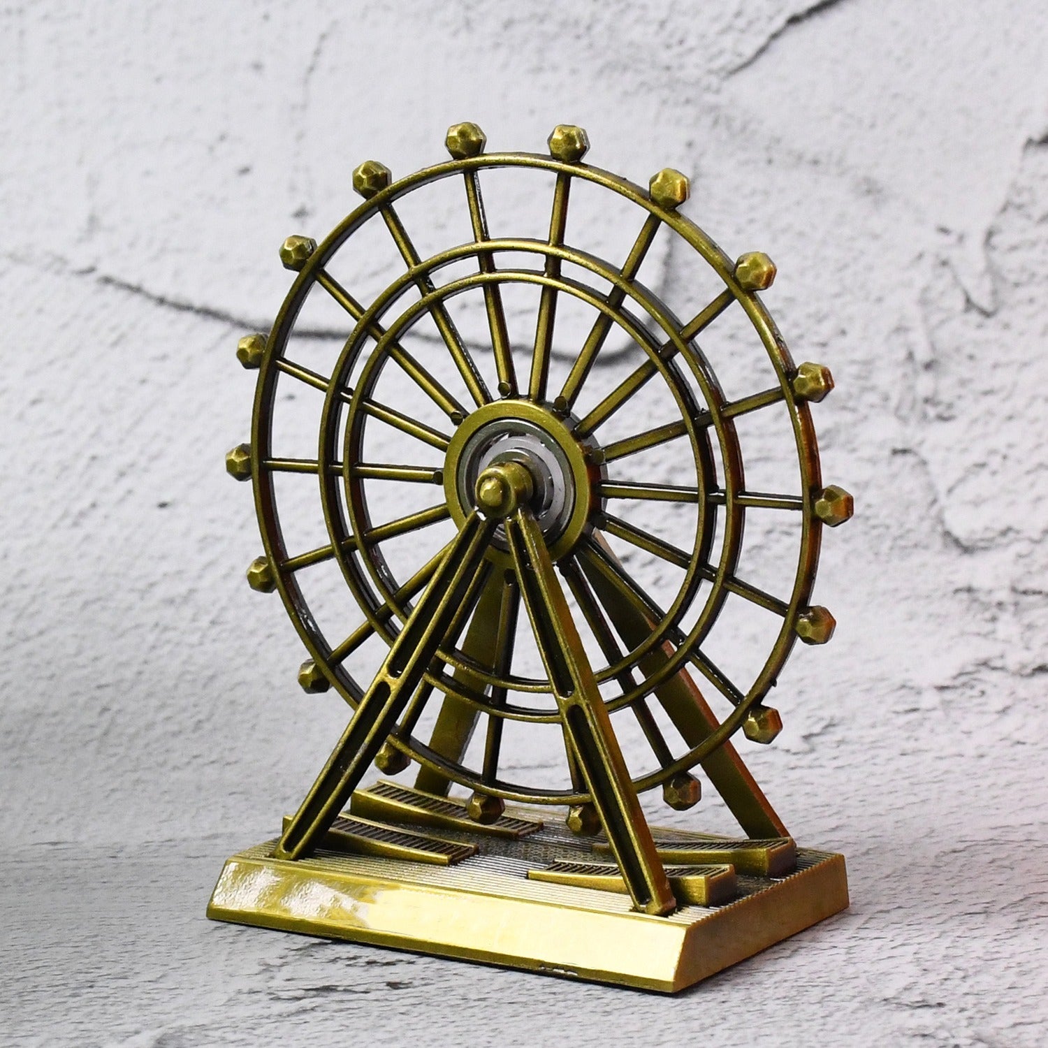 Metal desktop wheel tower ornament with intricate design on table